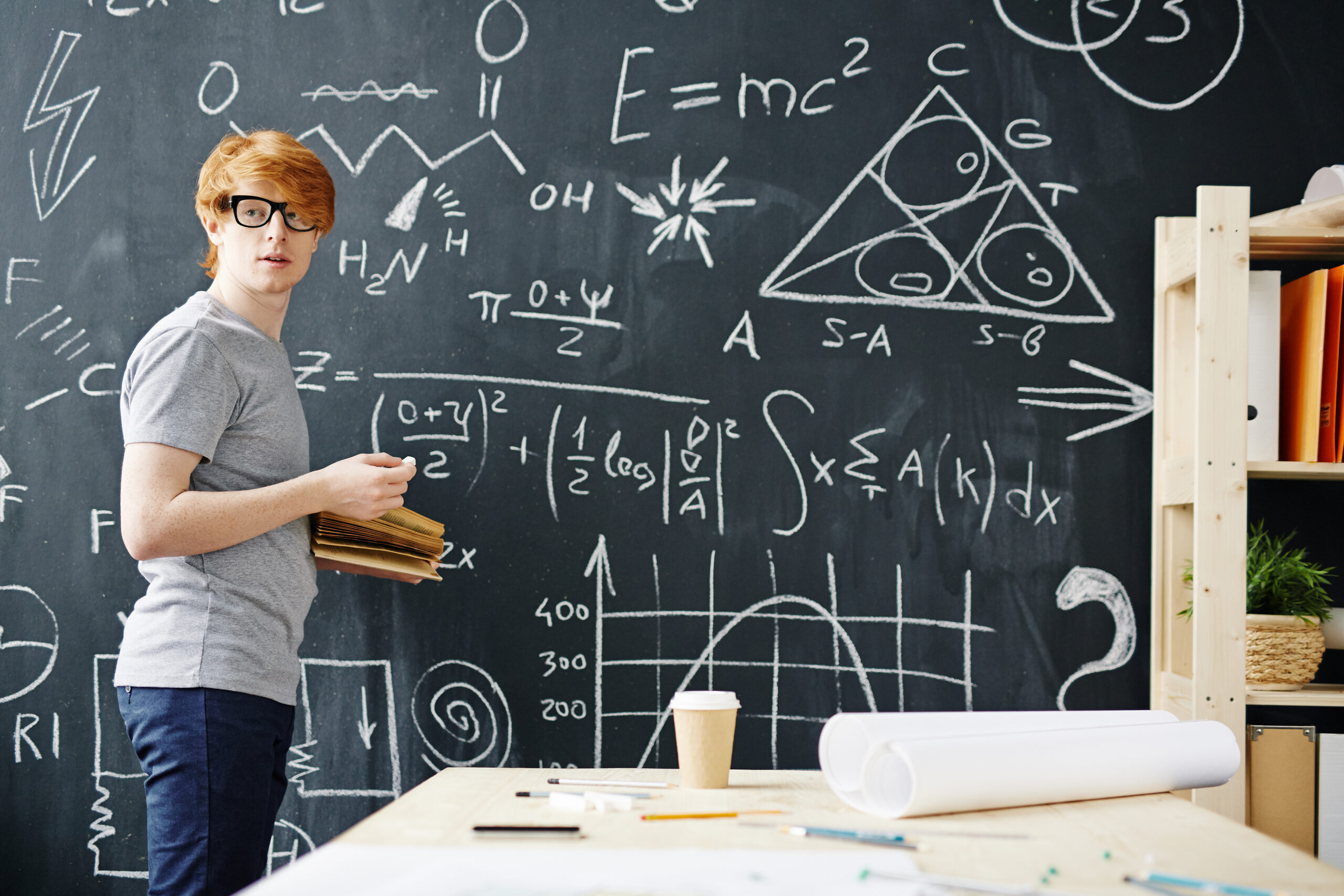 Young Scientist Working at Blackboard